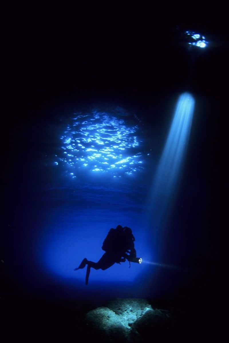 Technical diver in a blue passage near Vis